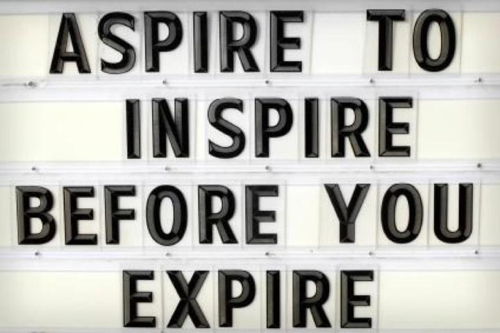 Sign saying Aspire to Inspire Before You Expire